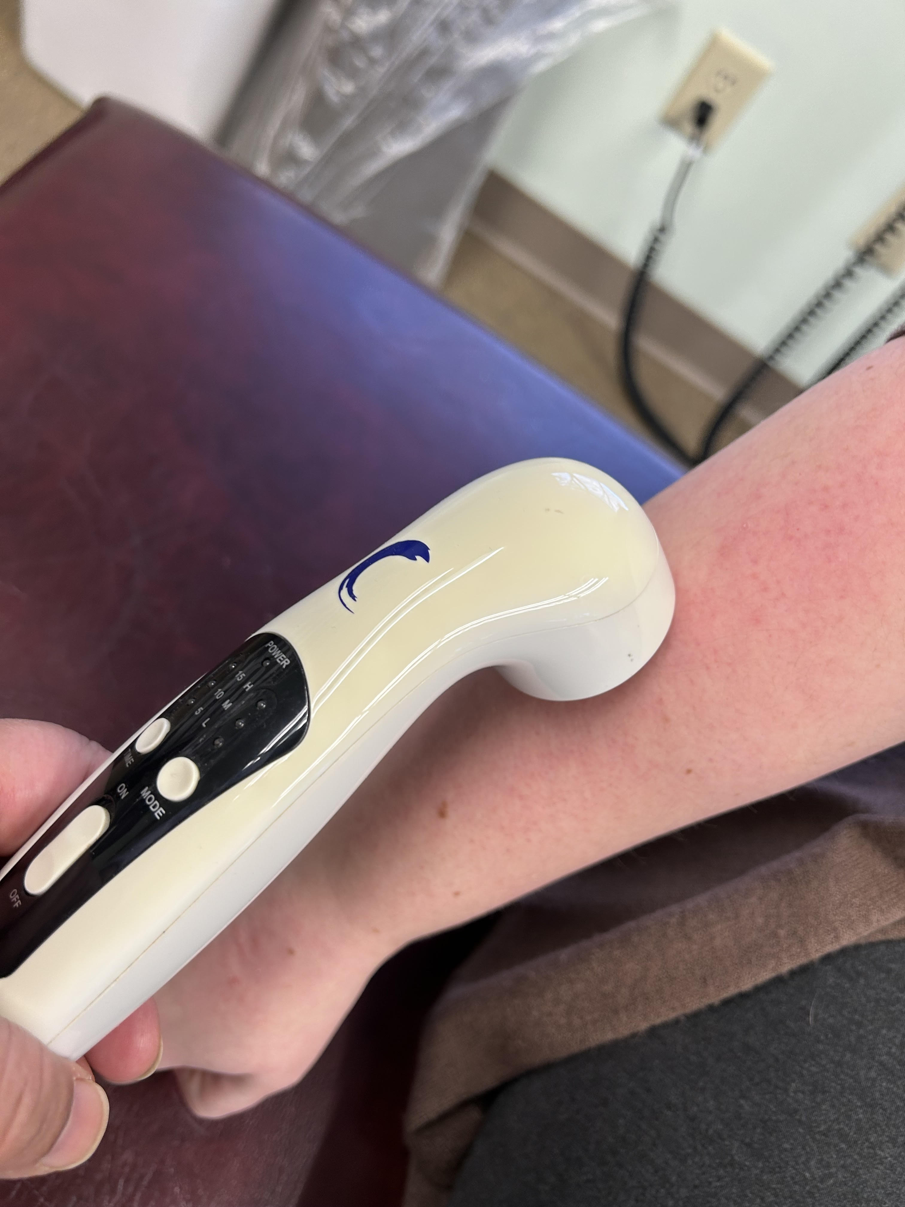 Patient receiving ultrasound therapy on their arm